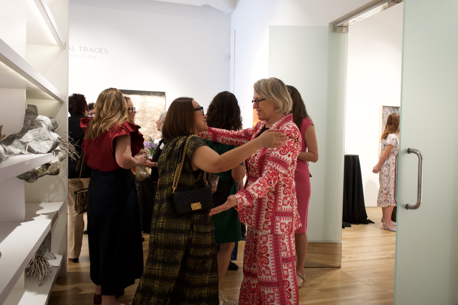 Human connection — embrace between gallery visitors